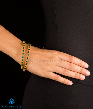 Stunning gold coated bangles with green gemstones